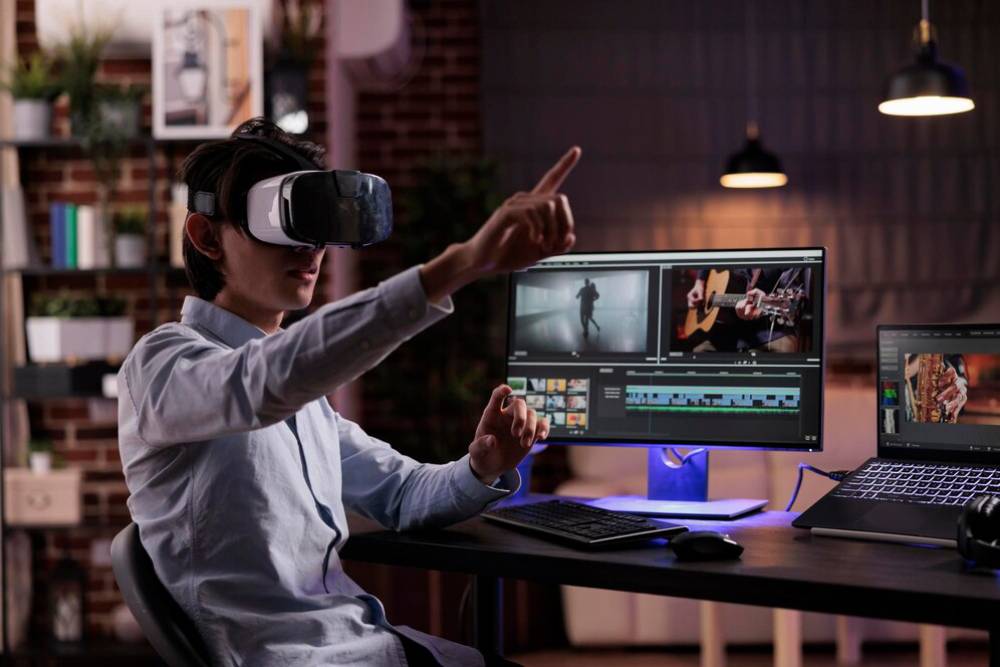 A person wearing a VR headset interacts with dual monitors displaying video editing software in a stylish, dimly lit workspace.